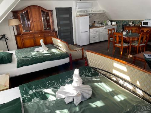 a living room with two beds and a kitchen at Ubytování U Synagogy Dobříš in Dobříš