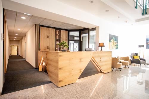a lobby with a reception desk in a building at Hotel Bessunger Forst in Roßdorf