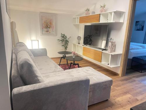 a living room with a couch and a table at Komfort-Apartments Waidring in Waidring