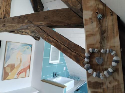 La salle de bains est pourvue d'un lavabo et d'un plafond en bois. dans l'établissement Gîte 3* La Colinette, Lac du Bourget(3 km), à Saint-Pierre-de-Curtille