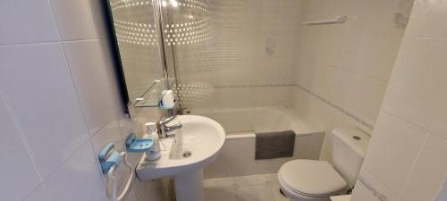 a white bathroom with a sink and a toilet at Apartment Riviera del Sol - Seaview in Mijas Costa