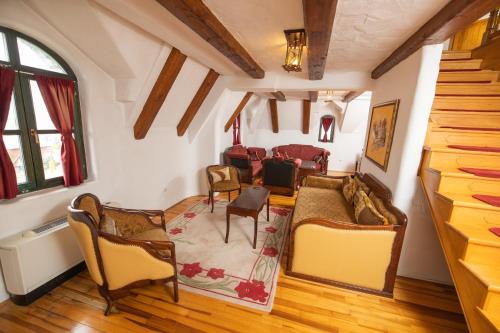a living room with chairs and a couch at Etno selo Stanišići Hotel Pirg in Dvorovi