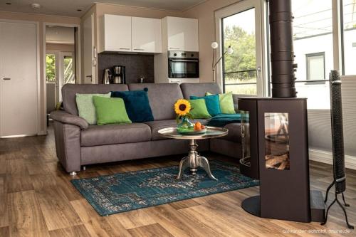 a living room with a couch and a table at Hausboot KonTiki - LP8 in Laasow