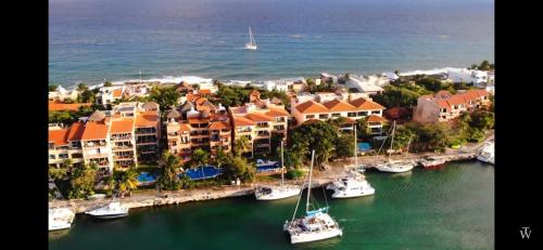 an aerial view of a harbor with boats in the water at Sunset & Boat Watching Balcony SOL-QR-LTL-2025- 00508 in Puerto Aventuras