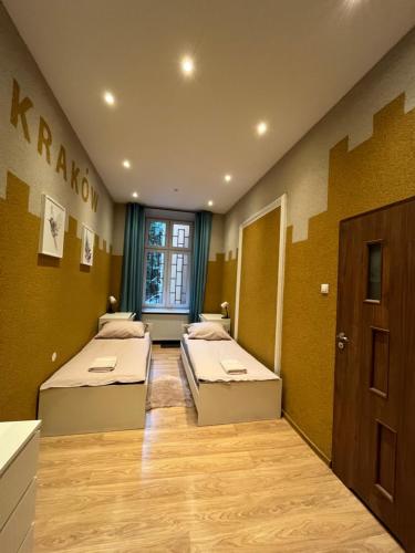 Habitación con 2 camas y puerta. en Girls Hostel en Cracovia