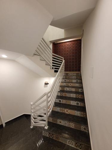 a staircase in a building with a white stair case at The Regal Luxury Boutique Stays in Majorda