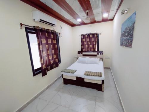a bedroom with a bed and a window in it at Hotel Seaview in Murud