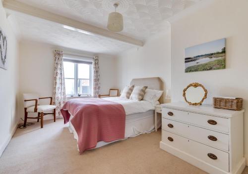 a bedroom with a bed and a dresser and a window at Alma Rise in Melton