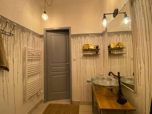 a bathroom with a glass sink and a mirror at Invitation au voyage sur cour in Sète