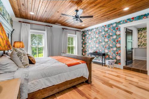 a bedroom with a bed and a wooden ceiling at Luxury Mountain Mansion, 7BR, 8 king beds, 10000sf, Views, Pool, Sport Court, Gym, Sauna, Petting Zoo in Blue Ridge