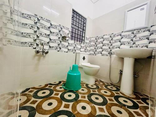 uma casa de banho com um lavatório e um WC em JM Suites em Tezpur