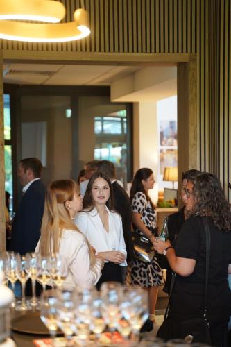 a group of people standing around a table with wine glasses at Hotel Bessunger Forst in Roßdorf