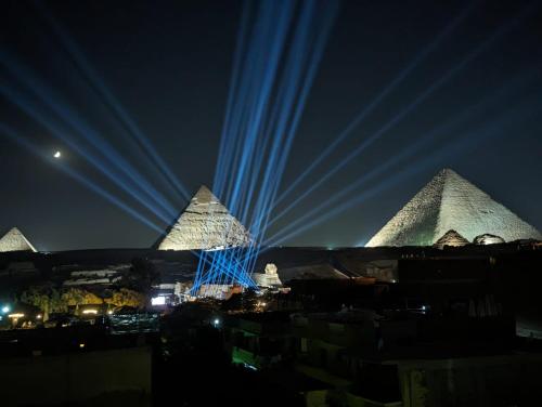 a view of the pyramids of giza at night at Narmer Pyramids View in Cairo