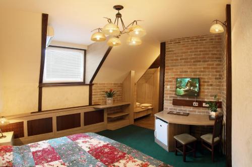 a bedroom with a bed and a desk and a window at Família Vendégház in Szeged
