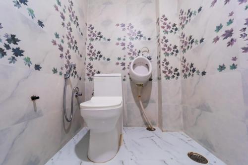 a bathroom with a toilet and a sink at The Roma Homestay in Sarnath Varanasi in Varanasi