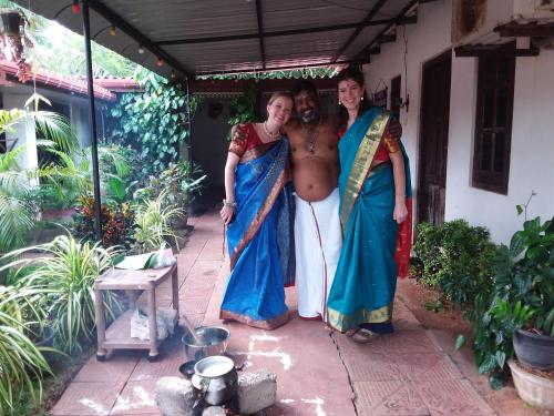 two women and a man in saris posing for a picture at UPPUVELI BEACH HOUSE in Trincomalee
