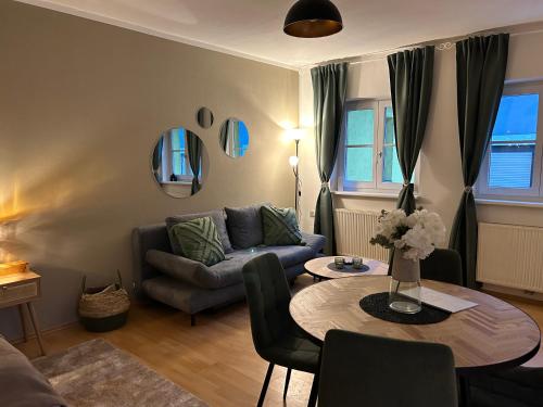 a living room with a couch and a table at Wohntraum im Herzen von Pregarten in Pregarten
