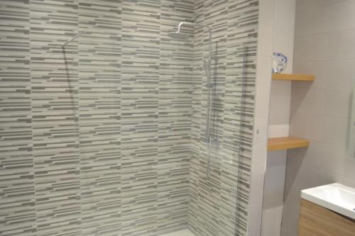 a shower with a glass door in a bathroom at Ashbrooke Homestay in Sunderland