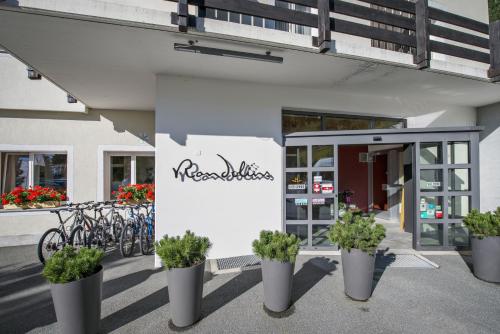 a building with bikes parked outside of a building at Hostel by Randolins in St. Moritz