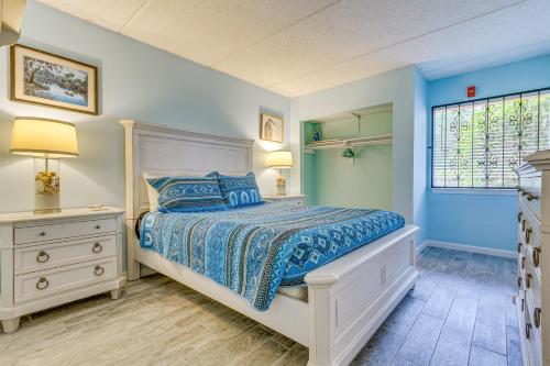 a bedroom with a bed with blue walls and a window at Central Mary Esther Condo 5 Mi to Okaloosa Island! in Mary Esther