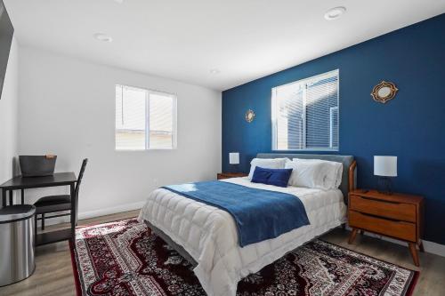 a blue bedroom with a bed with a blue wall at Good Shepard Homestay in Los Angeles