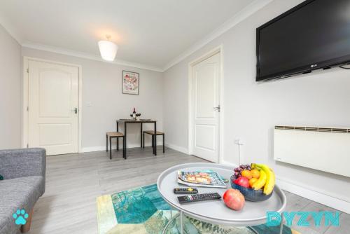 a living room with a table with a bowl of fruit at WiFi | Parking | Comfort in Cardiff