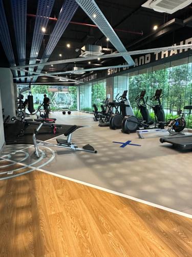a gym with a bunch of treadmills and exercise bikes at Sentral Luxury Suites KL in Kuala Lumpur