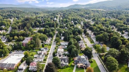an aerial view of a town with houses and trees at South Shire in Bennington