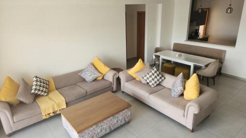 a living room with two couches and a table at SURF PALACE BEACHFRONT APARTMENT Essaouira in Essaouira