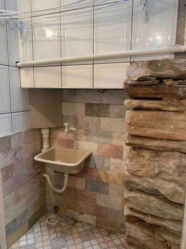 a bathroom with a sink and a pile of rocks at Casa Antônio Dias in Ouro Preto