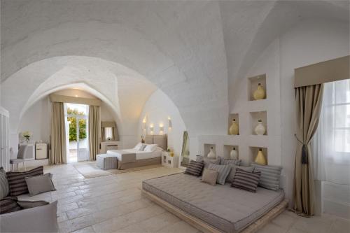 מיטה או מיטות בחדר ב-Baglioni Masseria Muzza