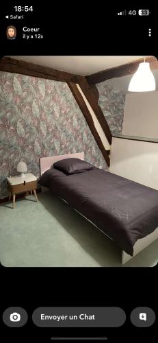 1 dormitorio con 1 cama y una pared con flores en Maison campagne, 