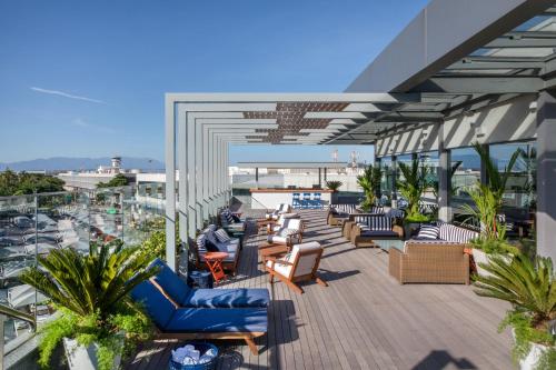 a patio with couches and chairs on a building at Prodigy Santos Dumont in Rio de Janeiro