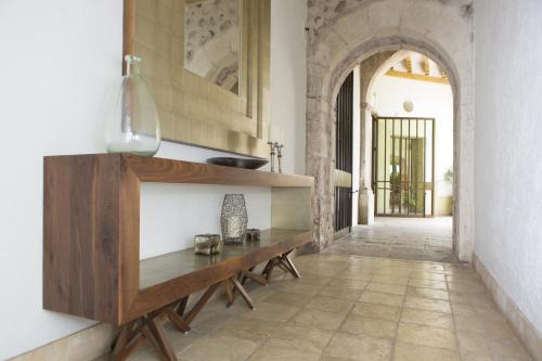 a dining room with a table and a hallway at Doña Urraca Hotel & Spa in Querétaro
