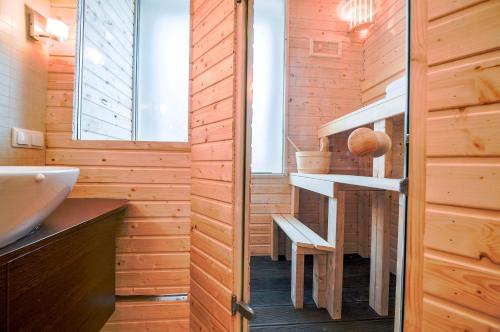 a bathroom with wooden walls and a sink and a staircase at CITYSTAY Gdynia Śródmieście Apartament z sauną in Gdynia