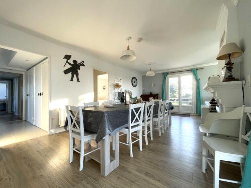 a kitchen and dining room with a table and chairs at Amazing VILLA with Exceptional Panoramic views over Dunes protected natural site and Sea - Entire House or apt in Le Touquet-Paris-Plage