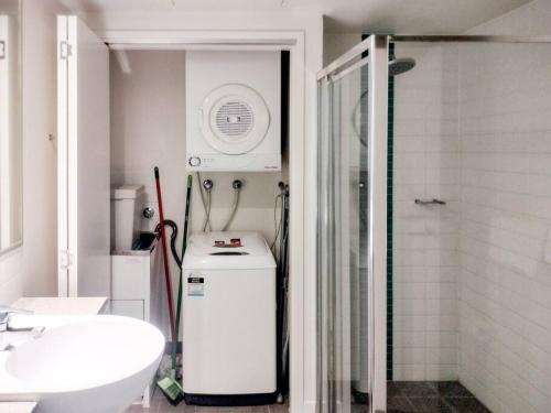 a bathroom with a shower and a small refrigerator at Location! Inner City 1B1B Apt w/Pool,Gym, Sauna in Brisbane