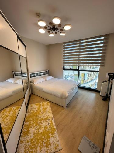 a bedroom with two beds and a ceiling fan at stylish flat-eagle eye for istanbul in Istanbul