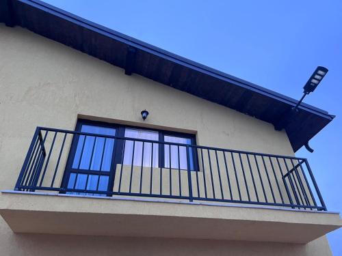 a balcony with a blue railing on a building at Casa Ratiu 3 Stele Airport Bucharest Therme Bucharest in Baloteşti