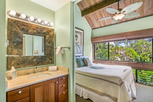 um quarto com uma cama, um lavatório e uma janela em Unique Oceanfront Condo with AC- Alekona Kauai em Koloa