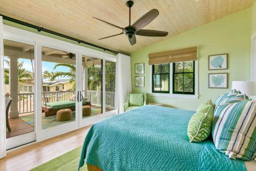 a bedroom with a bed and a ceiling fan at 4BR Poipu Home with Private Pool- Alekona Kauai in Koloa