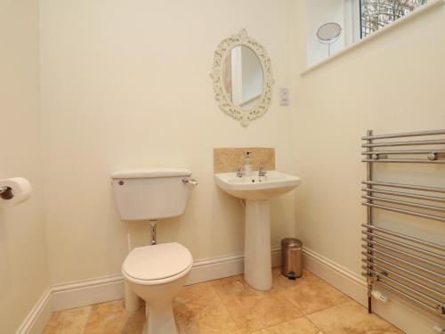 a bathroom with a toilet and a sink at Little Silver Nugget in High Bickington