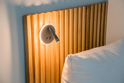 a room with a bed and a wooden wall at Nena Apartments Berlin Adlershof in Berlin