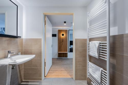 a bathroom with a sink and a mirror at Nena Apartments Berlin Adlershof in Berlin