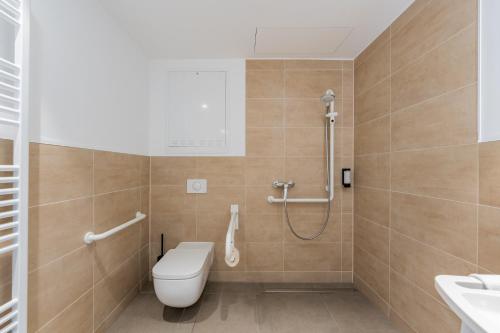 a bathroom with a toilet and a shower at Nena Apartments Berlin Adlershof in Berlin