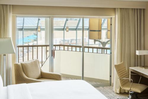 a hotel room with a bed and a balcony at DoubleTree by Hilton Orlando Airport Hotel in Orlando