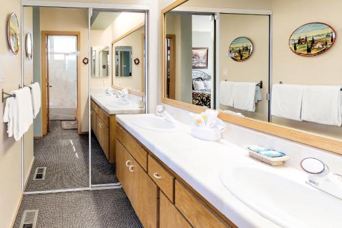 a bathroom with two sinks and two mirrors at Snowcreek 847 in Mammoth Lakes