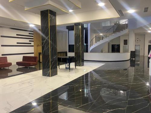 a lobby with a piano and a staircase in a building at Tsaghkadzor Alvina Complex 12 Project in Tsaghkadzor