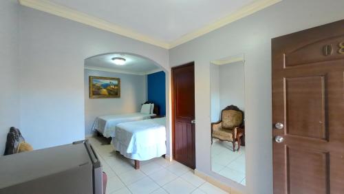 a room with a bedroom with a bed and a door at Hotel Florencia in San Miguel
