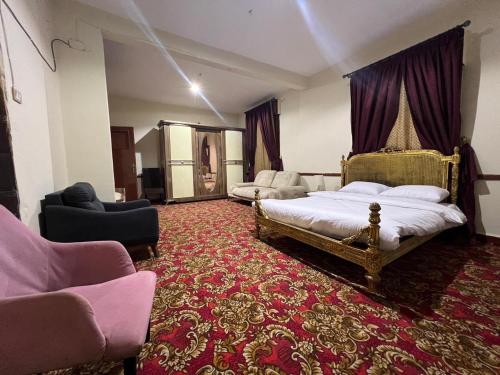 a bedroom with two beds and a red carpet at Le Caire Guest Hous cairo in Cairo